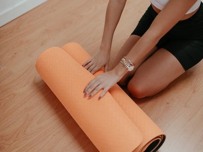 Rolled yoga mat on a wooden floor